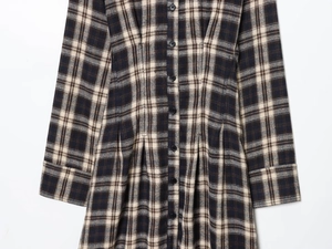 Detailed view of plaid midi dress featuring pleated waist and button-up front closure