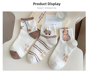 Three pairs of white cotton ankle socks featuring cute brown capybara embroidery designs