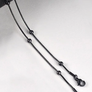 Close-up of black stainless steel beaded snake chain with a secure lobster clasp