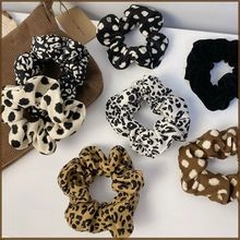 Close-up of leopard print and polka dot scrunchie hair ties made of soft fabric