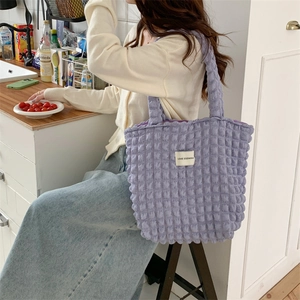 Detail of light purple bubble texture tote bag with LOVE SOZAKKA woven label on soft fabric