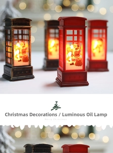 Close-up of vintage telephone booth LED lantern with Santa Claus and warm yellow light