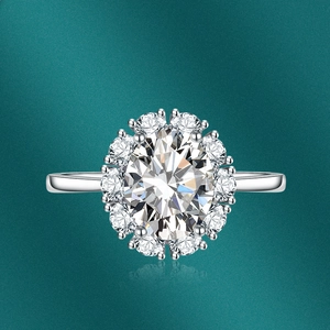 Macro shot of oval cut gemstone ring with sparkling diamond halo on green gradient background