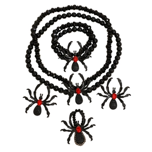 Gothic spider jewelry set with black beads and vibrant red rhinestones on white background
