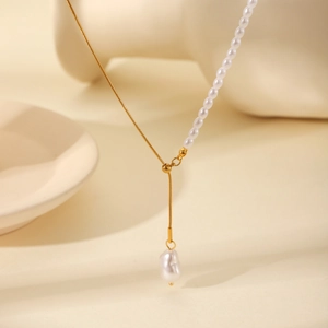 Gold stainless steel snake chain necklace with asymmetrical white pearls and baroque pendant