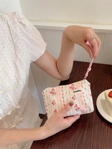 Floral cotton makeup bag with pink flower pattern and woven zipper strap for women