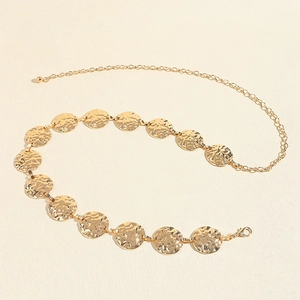 Detail view of gold metal chain belt with hammered texture circle links and lobster clasp