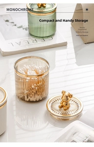 Detail of luxury ribbed glass canister with gold bear handle for cotton swabs