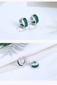 Detailed macro view of S925 sterling silver hoop earrings with faceted green agate stones
