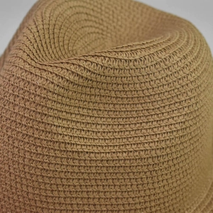 Macro shot of dense spiral woven texture on the top of a natural straw jazz hat