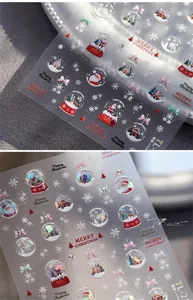 Macro detail of 3D embossed Christmas nail stickers featuring festive holiday patterns