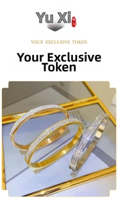 Macro view of three-row crystal paved bangle set in gold and silver stainless steel
