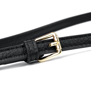 Detailed close-up of a black lychee textured leather strap with a gold metal buckle