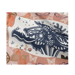 Detail of bohemian tapestry fabric showing blue dragon and butterfly patterns with stars