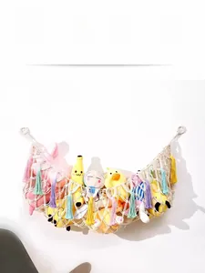 Detail of hand-woven cotton hammock with colorful tassels for plush toy storage