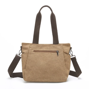 Minimalist khaki canvas tote bag with adjustable shoulder strap and front zipper pocket
