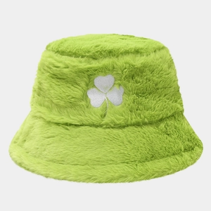 Close-up of bright green faux fur bucket hat with white clover embroidery texture