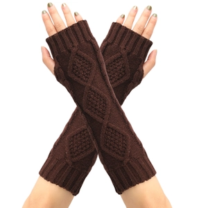 Detailed macro view of diamond cable knit pattern on dark brown arm warmer gloves