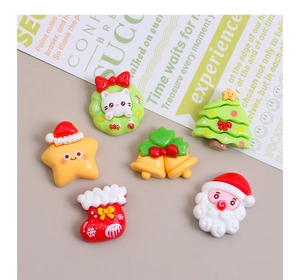 Detailed macro view of assorted Christmas resin charms including Santa, stars, and trees