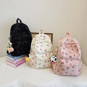 Corduroy cherry print backpacks in black, off-white, and pink for school or travel use