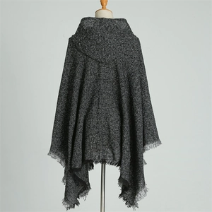 Rear view of a dark grey knit hooded poncho featuring fringed hem and soft boucle yarn