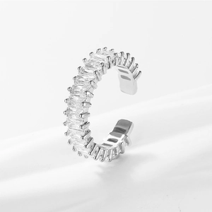 Close-up of adjustable silver ring featuring baguette-cut clear zircon in claw setting