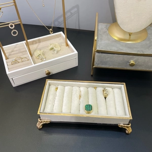 Elegant jewelry display set with white wooden drawers, gold metal rack and grey velvet box