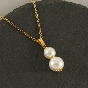 Golden titanium steel necklace with white double pearl gourd pendant on black stone
