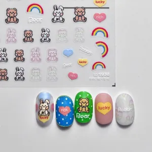 Cute self-adhesive nail stickers featuring bear and rabbit patterns with rainbow designs