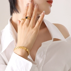Gold H-link bracelet with black enamel smiley ring and Cuban chain ring set for women