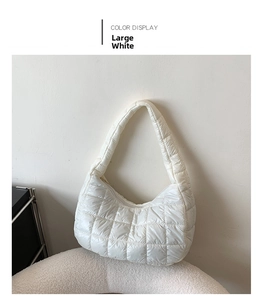 Detail shot of the large white quilted dumpling bag with a soft glossy texture