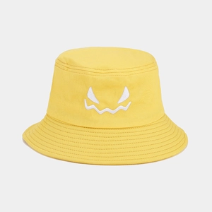 Detail of yellow cotton bucket hat with white embroidered monster face and stitched brim