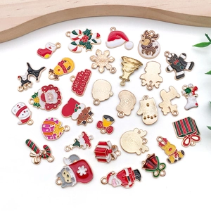 Flat lay of colorful Christmas charms including Santa, elk, and snowman for DIY jewelry