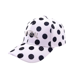 Detail of polka dot baseball cap featuring natural embroidery and 6-panel canvas structure