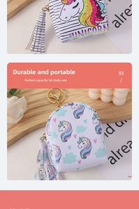 Detailed close-up of unicorn coin purse with colorful tassels and a metal keychain ring