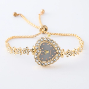 Detail of gold heart-shaped watch face with crystals and adjustable chain bracelet
