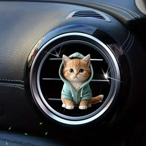 Close-up of a cute cartoon cat in a turquoise hoodie on a car air vent decoration
