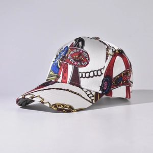 Detail view of a white satin baseball cap featuring luxury golden chain and royal prints