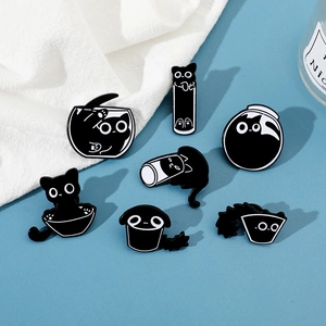 Close-up of seven cartoon black cat enamel pins in various poses and containers