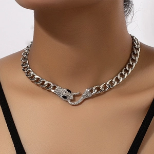 Close-up of silver Cuban chain necklace with sparkling rhinestone snake head clasp