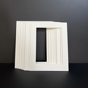 Stack of white rectangle picture frame mats for photo mounting and art framing