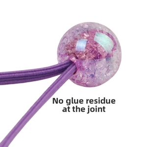 Macro shot of purple elastic hair tie detail showing seamless bead interface