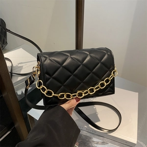Quilted black leather mini crossbody bag with gold chain strap and modern flap closure