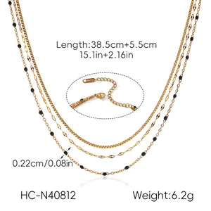 Detail of triple-layer gold stainless steel necklace with round beads and S.Steel stamp