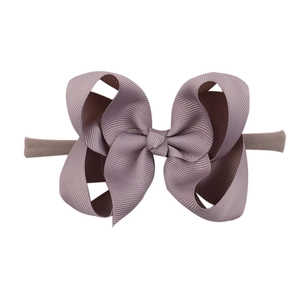 Detailed view of soft purple nylon headband with a textured grosgrain ribbon bow