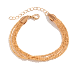 Macro shot of multi-layer golden alloy link bracelet with lobster clasp and extension