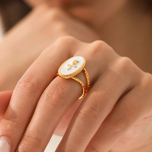Elegant gold stainless steel open ring featuring a white oval enamel rose relief design