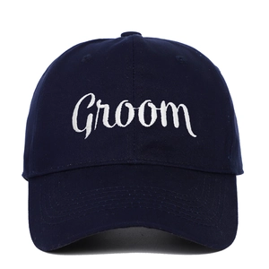Detailed embroidery of white Groom text on a dark blue cotton twill baseball cap