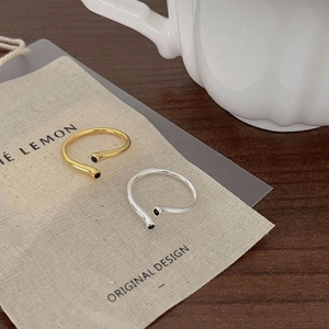 Minimalist adjustable silver and gold open rings with black zircon accents on card