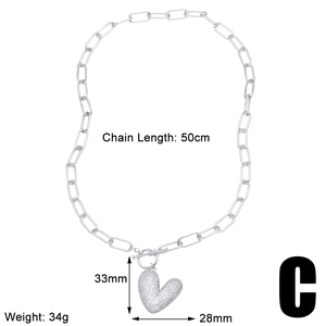 Macro shot of silver heart pendant with dimensions 33mm by 28mm and 50cm chain length
